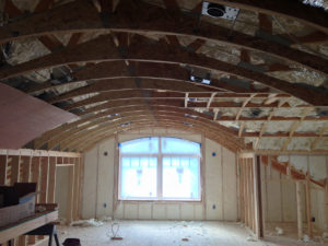 Room under construction with exposed insulating foam in the walls and ceiling