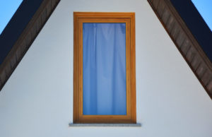 Single colorful window in a plain white wall
