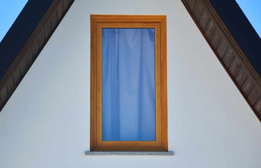 Single colorful window in a plain white wall